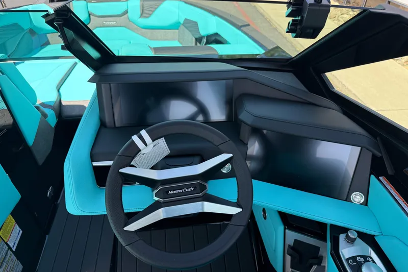 Slide: The Image of 2026 MasterCraft X24 boat interior with modern dashboard and turquoise seating. - 26