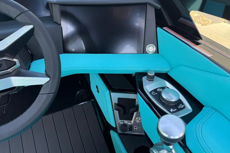 Slide: The Image of Interior of 2026 MasterCraft X24 boat with modern controls and turquoise accents. - 27