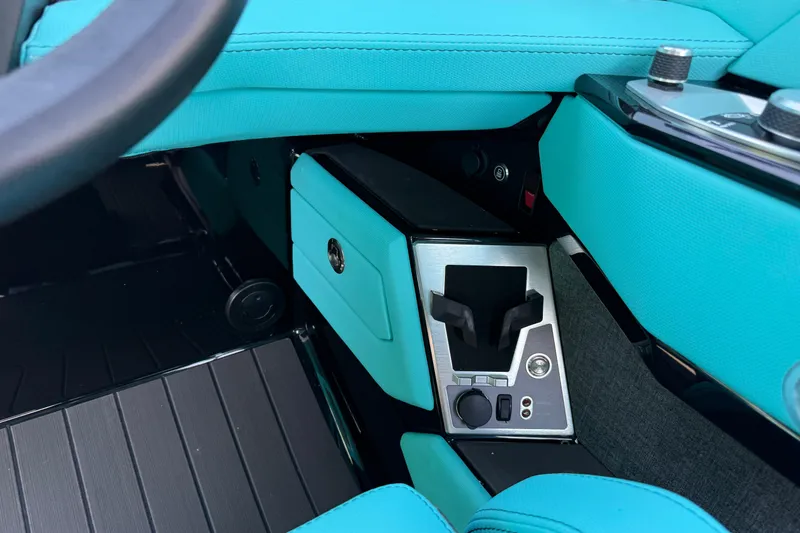 Slide: The Image of Interior of 2026 MasterCraft X24 boat with turquoise upholstery and modern controls. - 28