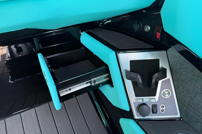 Slide: The Image of Interior of 2026 MasterCraft X24 boat with teal accents and control panel. - 29