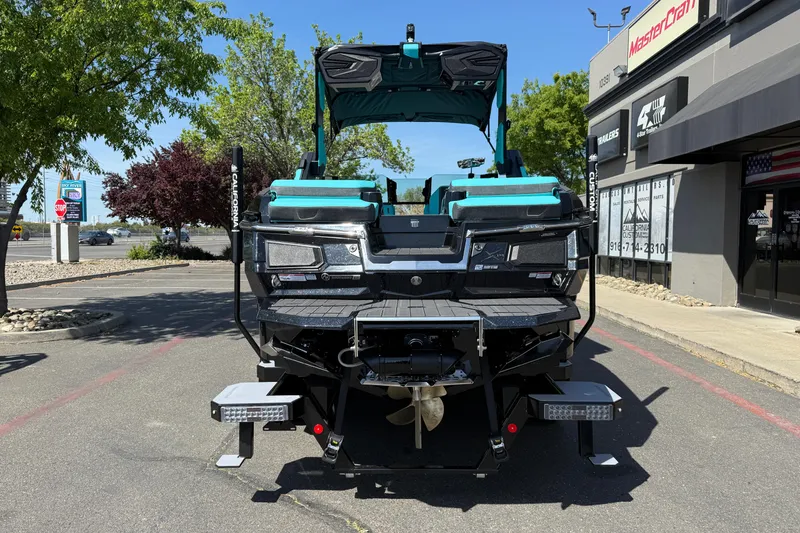 Slide: The Image of 2026 MasterCraft X24 boat displayed outdoors near dealership. - 3