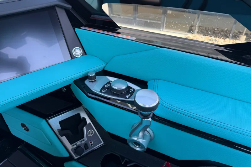 Slide: The Image of Interior of 2026 MasterCraft X24 boat with turquoise upholstery and control panel. - 30
