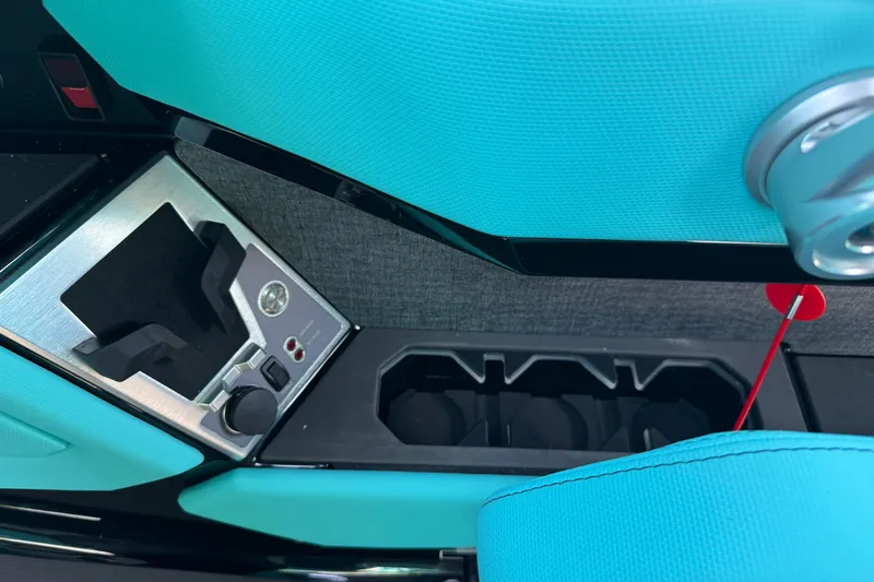 Slide: The Image of Interior of 2026 MasterCraft X24 boat featuring turquoise upholstery and control panel. - 31