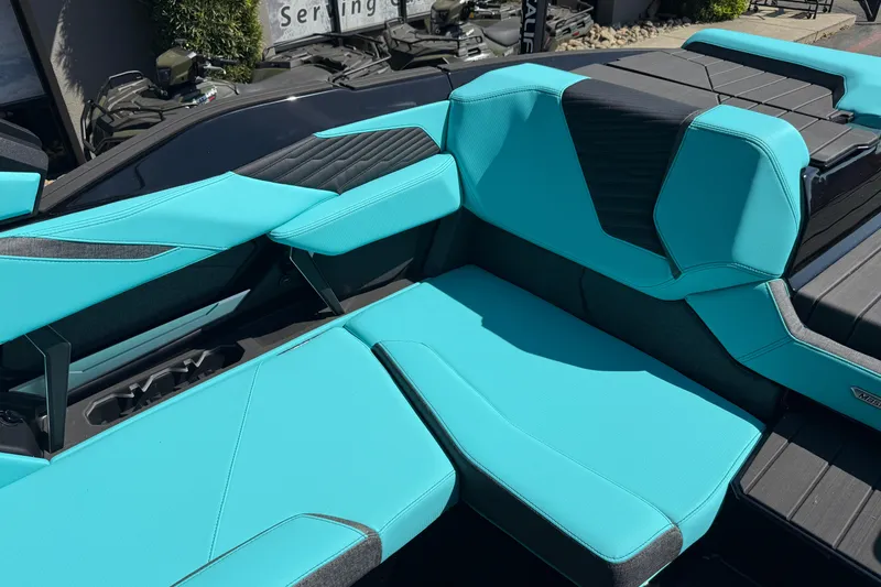 Slide: The Image of 2026 MasterCraft X24 boat interior with turquoise seating and black accents. - 36