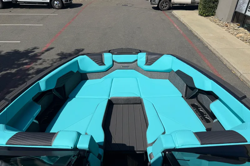 Slide: The Image of 2026 MasterCraft X24 boat interior with turquoise seating and sleek design. - 48