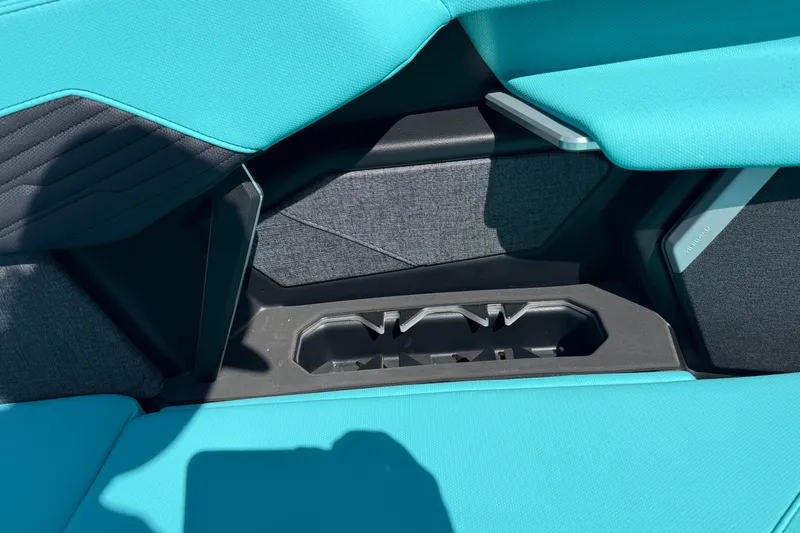Slide: The Image of Interior of 2026 MasterCraft X24 boat with teal seating and cup holder. - 57