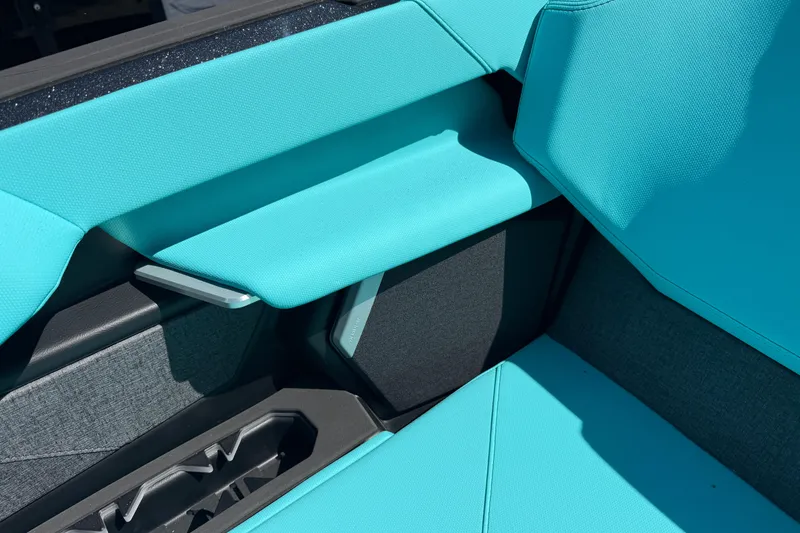 Slide: The Image of 2026 MasterCraft X24 interior with turquoise upholstery and cup holders. - 58