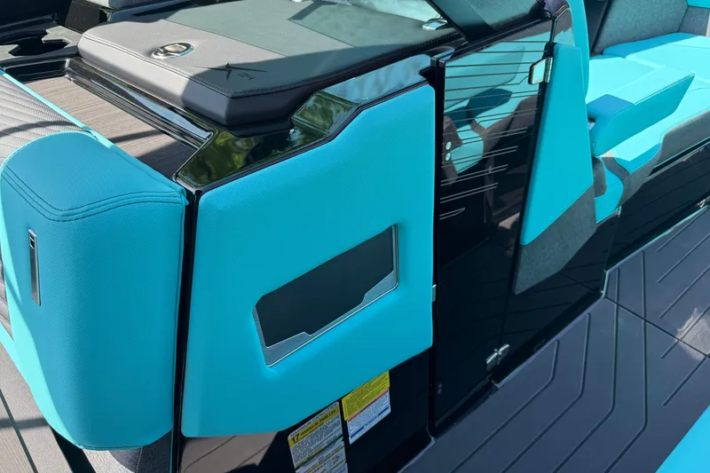 Slide: The Image of 2026 MasterCraft X24 boat interior with turquoise upholstery and sleek design. - 60