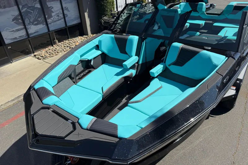 Slide: The Image of 2026 MasterCraft X24 boat with turquoise seating and sleek black exterior. - 68