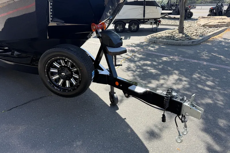 Slide: The Image of Trailer hitch of a 2026 MasterCraft X24 boat in a parking lot. - 7