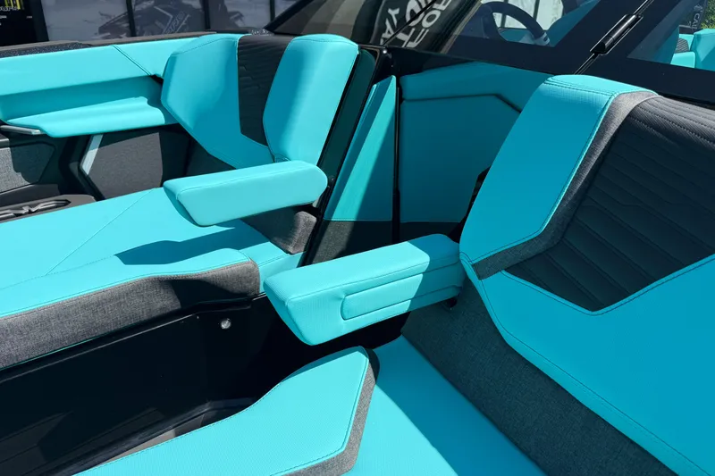 Slide: The Image of 2026 MasterCraft X24 interior with turquoise and gray seating, featuring armrests and modern design. - 74