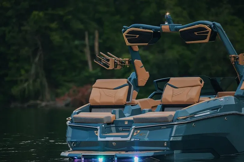 Slide: The Image of Manufacturer Provided Image: 2026 MasterCraft X24 boat with luxurious seating and sleek design on a calm lake. - 77