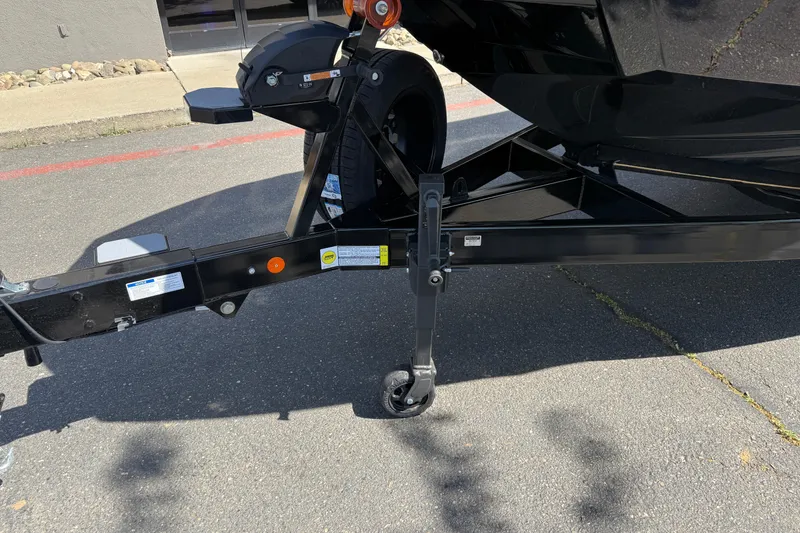 Slide: The Image of Trailer hitch of a 2026 MasterCraft X24 boat on pavement. - 8