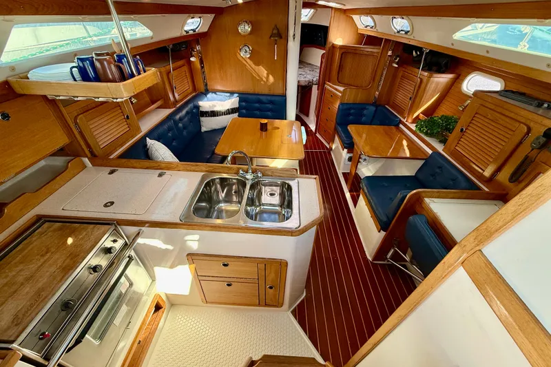 Slide: The Image of Interior of 2000 Catalina 36 MkII sailboat with wood finish and blue seating. - 16