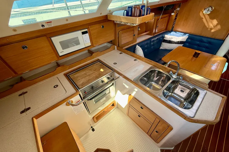 Slide: The Image of Interior of 2000 Catalina 36 MkII sailboat with kitchen and seating area. - 17