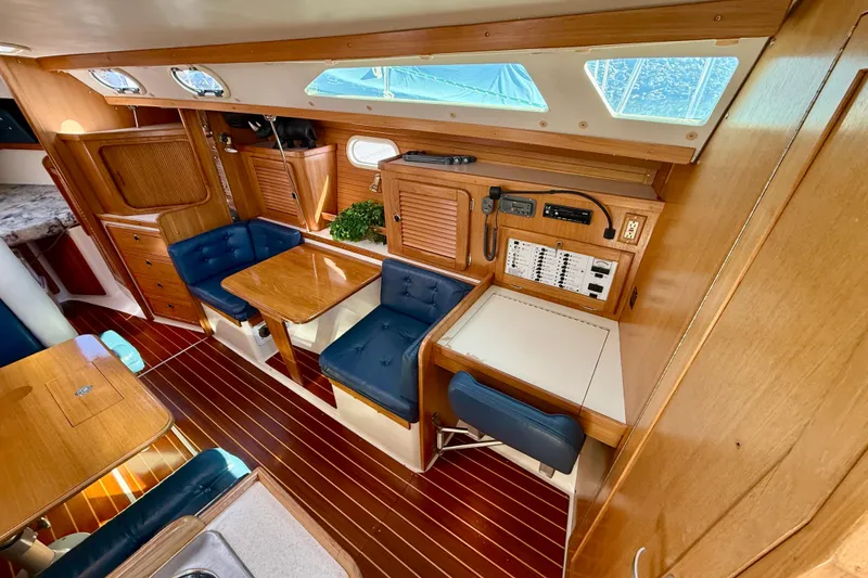 Slide: The Image of Interior of 2000 Catalina 36 MkII sailboat with wood finish and blue seating. - 18