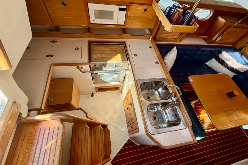 Slide: The Image of Interior of 2000 Catalina 36 MkII sailboat with kitchen and seating area. - 19