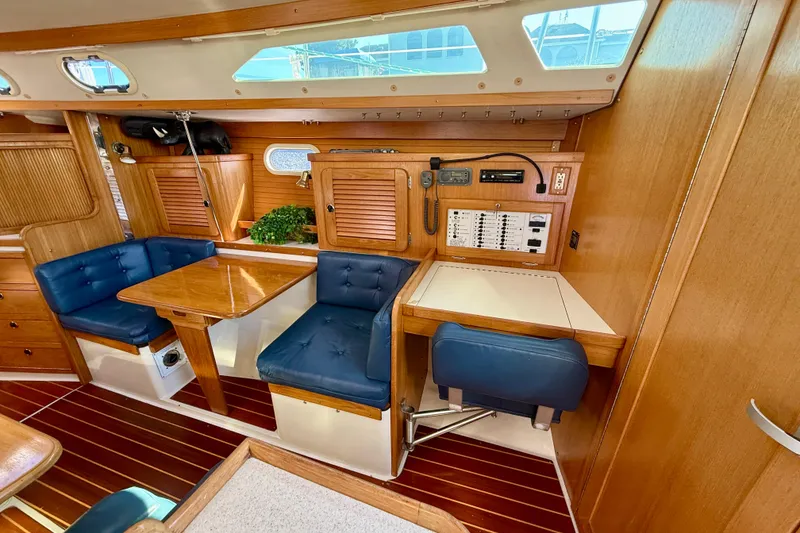 Slide: The Image of Interior of 2000 Catalina 36 MkII sailboat with wood finish and blue seating. - 21