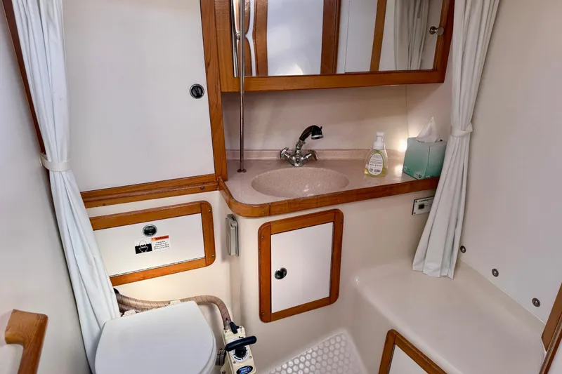 Slide: The Image of Bathroom interior of 2000 Catalina 36 MkII sailboat with sink, mirror, and toilet. - 25