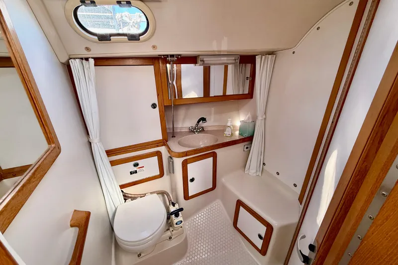 Slide: The Image of Bathroom interior of 2000 Catalina 36 MkII yacht, featuring sink, toilet, and storage. - 28