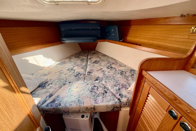 Slide: The Image of Cozy cabin interior of 2000 Catalina 36 MkII sailboat with patterned bedding. - 29