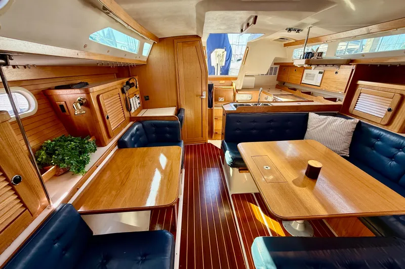 Slide: The Image of Interior of 2000 Catalina 36 MkII sailboat with wooden furnishings and blue seating. - 30