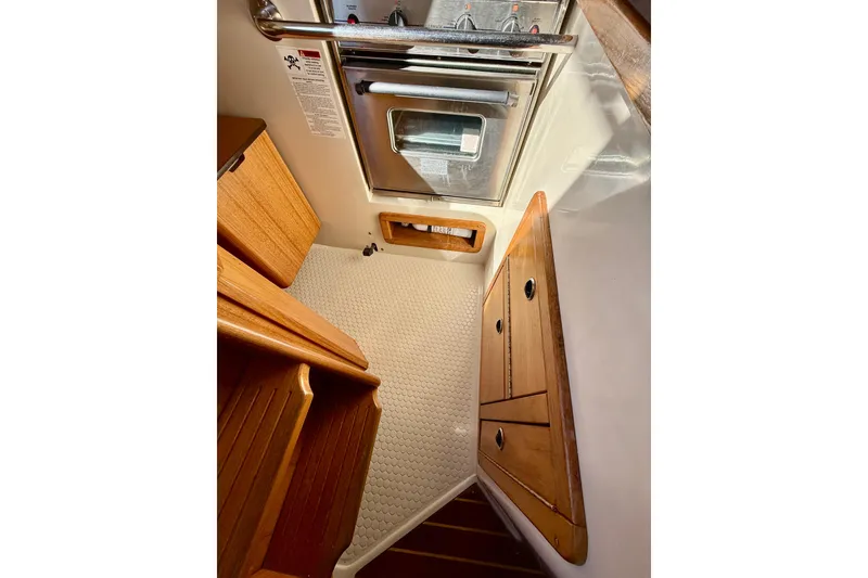 Slide: The Image of Catalina 36 MkII 2000 interior with wooden cabinetry and stainless steel oven. - 32
