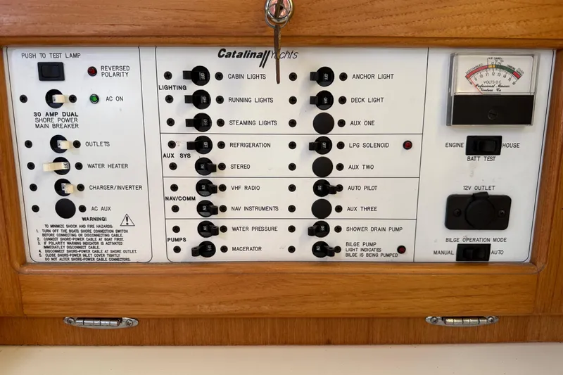 Slide: The Image of Electrical control panel of a 2000 Catalina 36 MkII yacht with various switches and gauges. - 40
