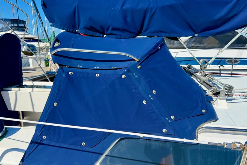 Slide: The Image of Blue canvas cover on a 2000 Catalina 36 MkII sailboat, docked at a marina. - 5
