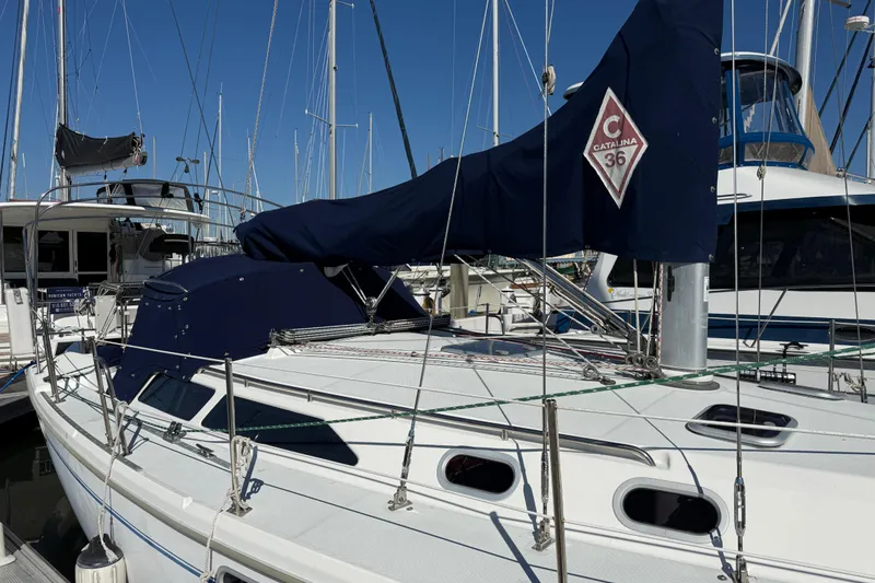 Slide: The Image of 2000 Catalina 36 MkII sailboat docked at marina, featuring covered mainsail and sleek design. - 8