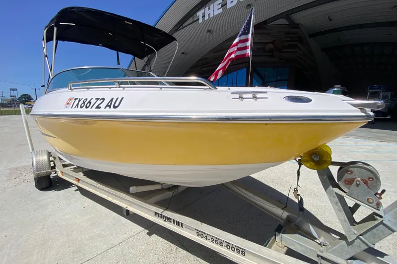 Slide: The Image of 2003 Monterey 208SI Montura boat on trailer with American flag in background. - 10