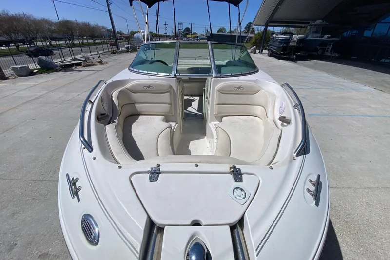 Slide: The Image of 2003 Monterey 208SI Montura boat with open bow seating, parked outdoors. - 11