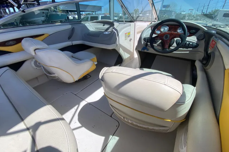 Slide: The Image of Interior of a 2003 Monterey 208SI Montura boat, featuring seating and steering wheel. - 14