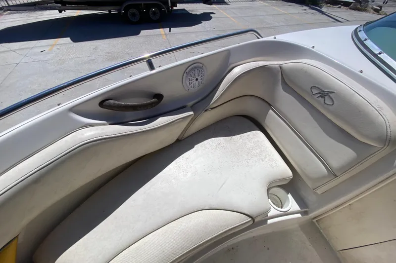 Slide: The Image of 2003 Monterey 208SI Montura boat interior with white cushioned seating and speaker. - 20