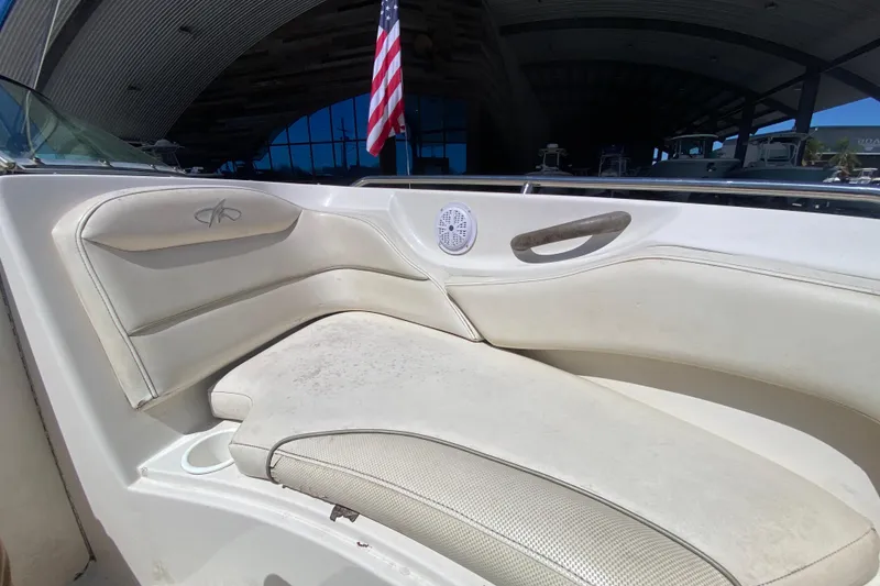 Slide: The Image of 2003 Monterey 208SI Montura boat interior with white seating and American flag. - 21