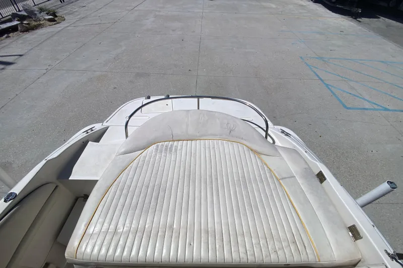 Slide: The Image of 2003 Monterey 208SI Montura boat with white cushioned seating on a concrete surface. - 22