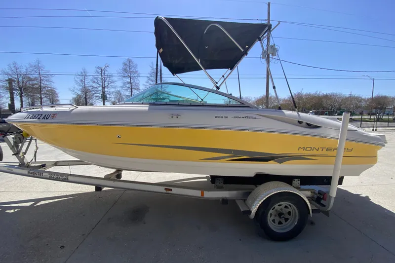 Slide: The Image of 2003 Monterey 208SI Montura boat on trailer, yellow and white design, with canopy. - 7