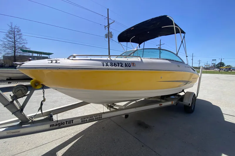 Slide: The Image of 2003 Monterey 208SI Montura boat on trailer, yellow hull, parked outdoors. - 8