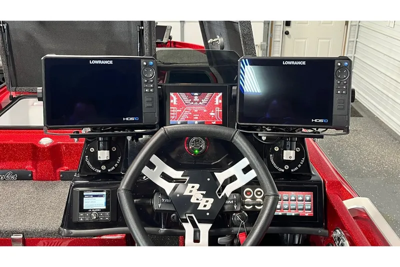 Slide: The Image of 2024 Bass Cat Puma STS dashboard with dual Lowrance HDS10 displays and steering wheel. - 13