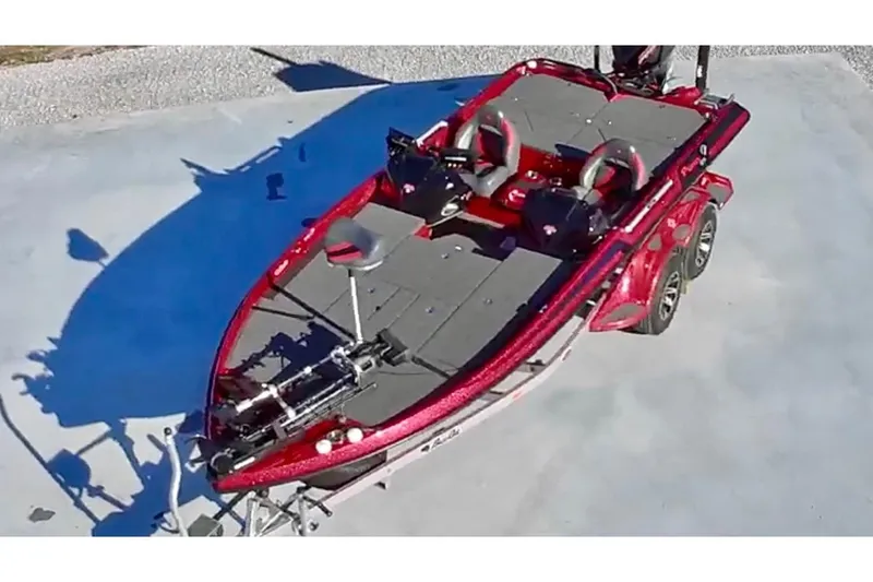 Slide: The Image of 2024 Bass Cat Puma STS boat, red exterior, dual seats, aerial view. - 2