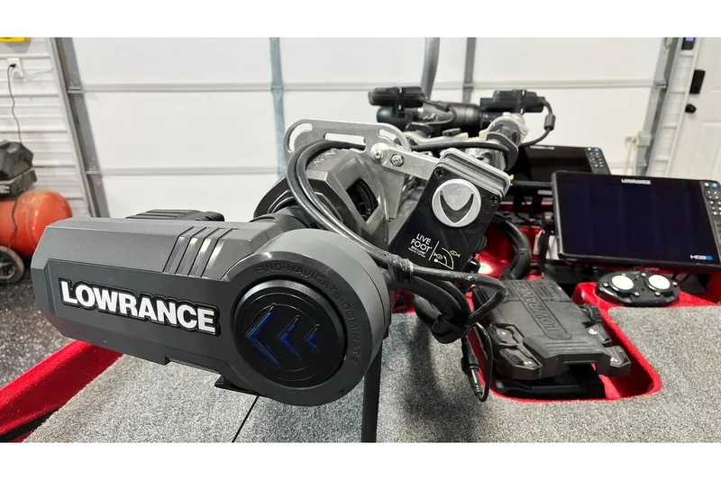 Slide: The Image of 2024 Bass Cat Puma STS with Lowrance electronics in a garage setting. - 7