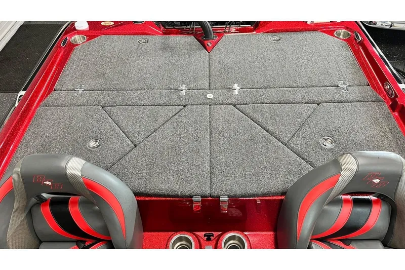 Slide: The Image of 2024 Bass Cat Puma STS boat interior with gray carpet and red accents. - 9