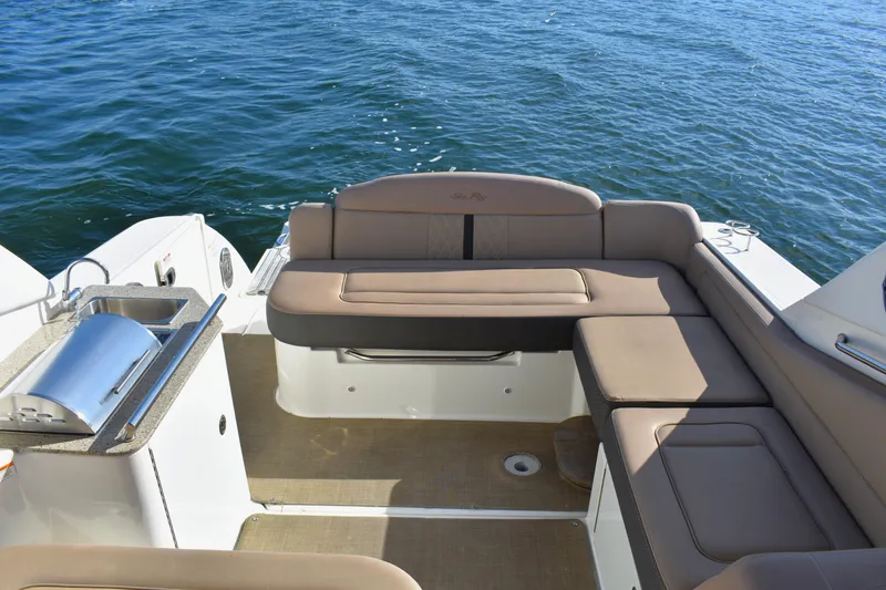 Slide: The Image of 2016 Sea Ray Sundancer 310 boat interior with seating and grill by the water. - 10