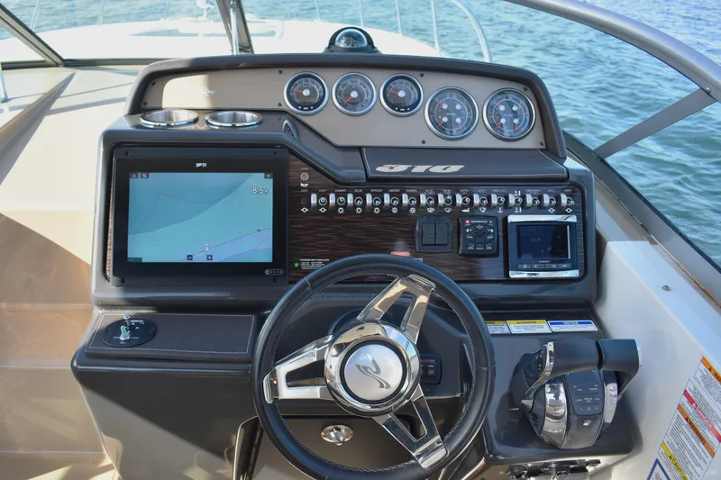 Slide: The Image of 2016 Sea Ray Sundancer 310 helm with navigation display and control panel. - 15