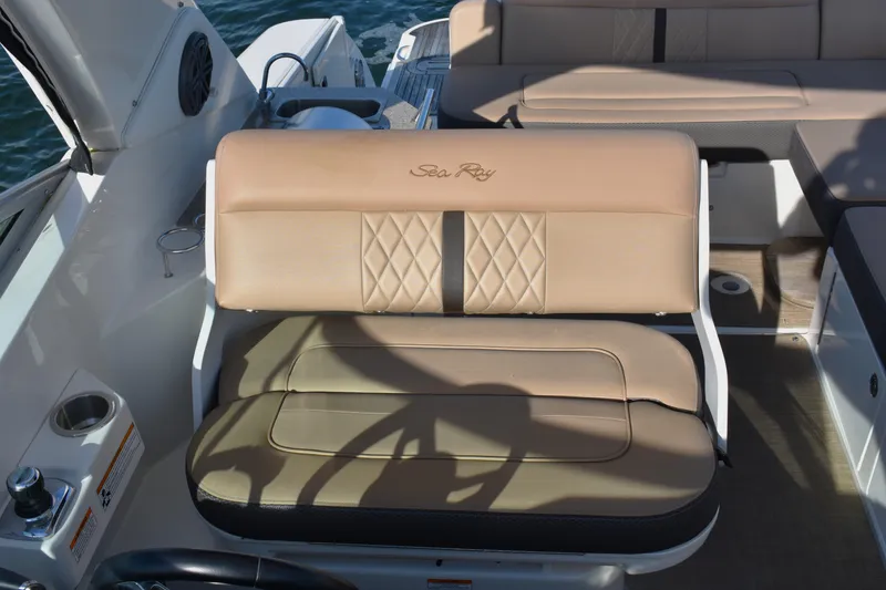 Slide: The Image of 2016 Sea Ray Sundancer 310 boat seating with beige upholstery and diamond stitching. - 16