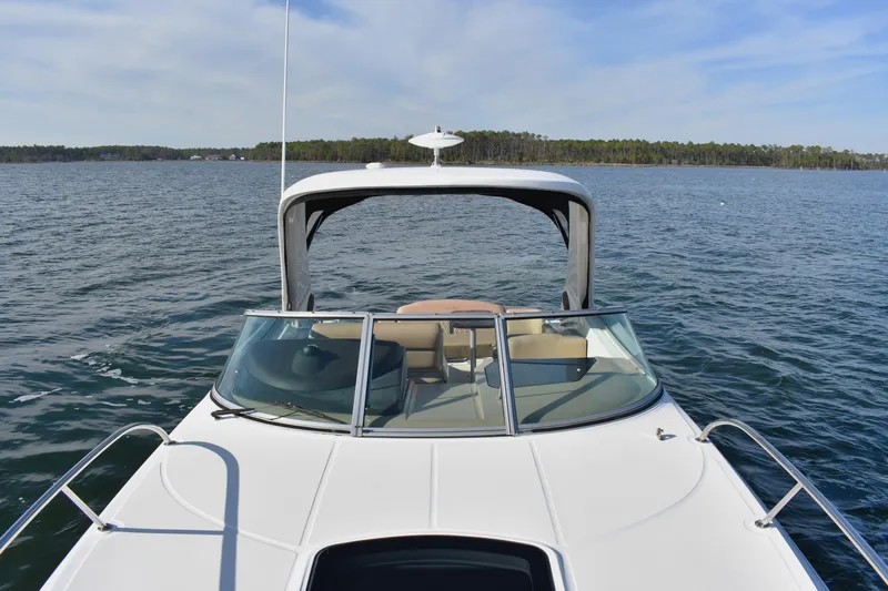 Slide: The Image of 2016 Sea Ray Sundancer 310 cruising on a calm lake under a clear sky. - 19