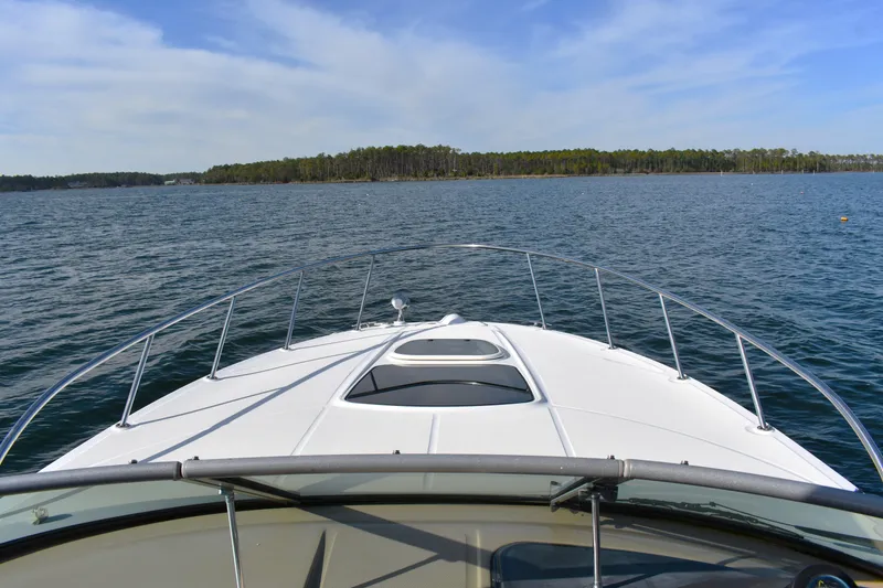 Slide: The Image of Bow view of 2016 Sea Ray Sundancer 310 cruising on a calm lake. - 20