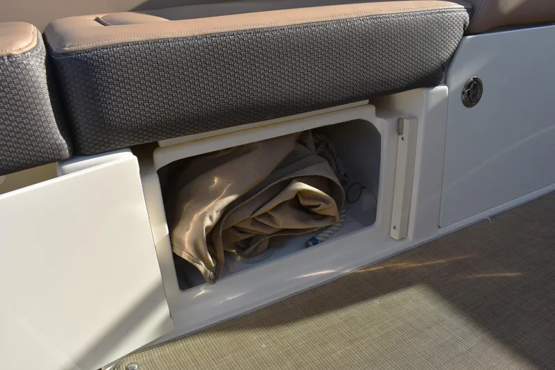 Slide: The Image of Storage compartment on a 2016 Sea Ray Sundancer 310 boat with fabric inside. - 23