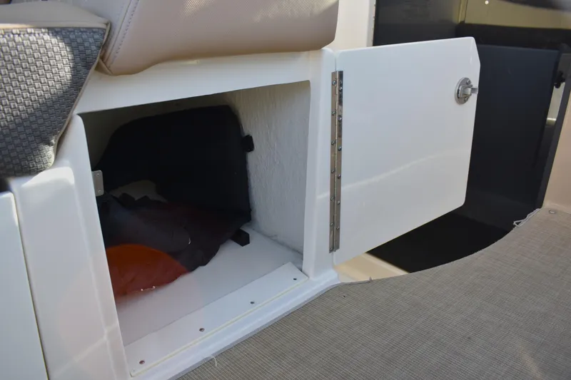 Slide: The Image of Open storage compartment on 2016 Sea Ray Sundancer 310 boat, showcasing interior space. - 24