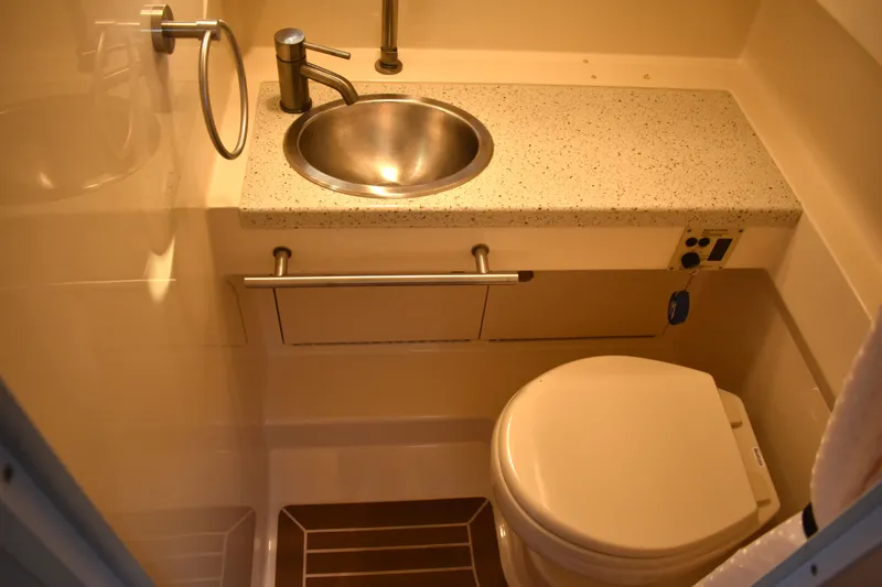 Slide: The Image of Compact bathroom in 2016 Sea Ray Sundancer 310 yacht with sink and toilet. - 26